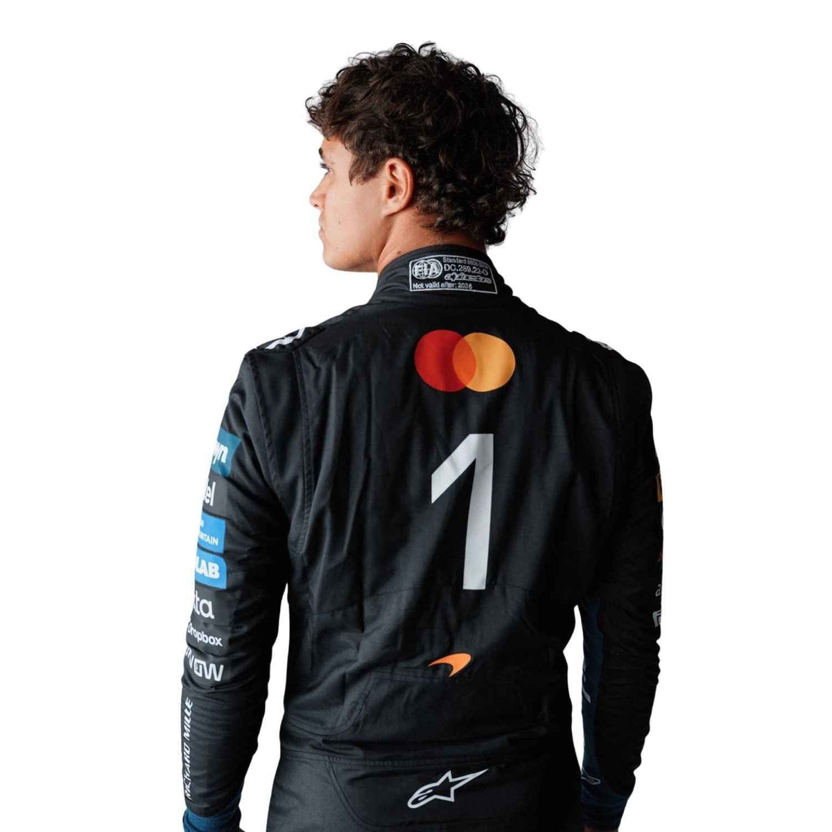 McLaren race suit worn in Lando Norris style, showcasing the full-length zip, shoulder epaulettes and race-day silhouette. A standout motorsport cosplay outfit and gift for any fan, karter or collector.
