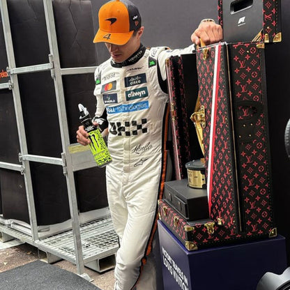 McLaren race suit worn in Lando Norris style, displaying the fitted one-piece cut with elasticated cuffs and a soft collar. A great F1 cosplay outfit for fans heading to a grand prix, a karting session or a themed party.